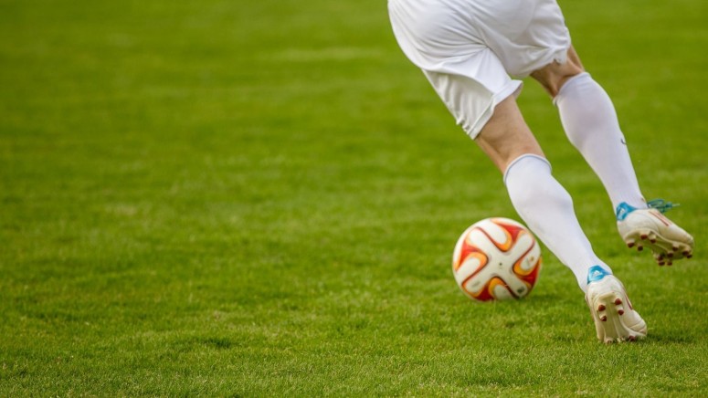 Football player prepares to hit the ball