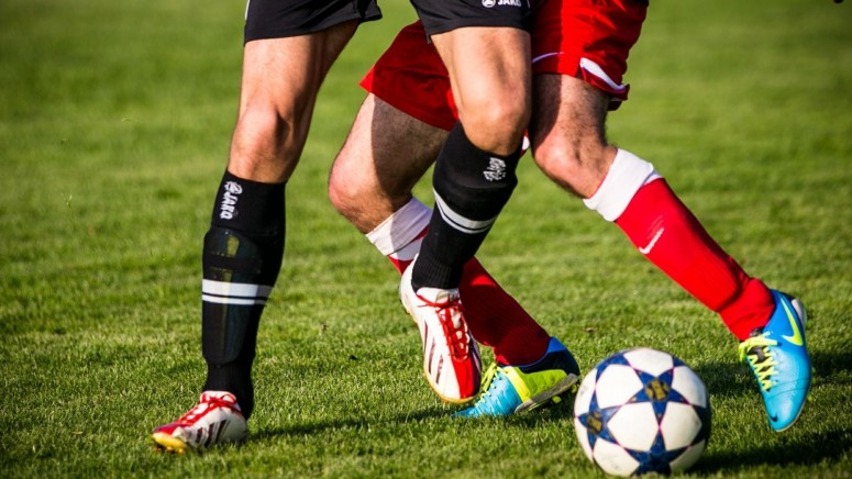 Soccer players fighting for possession