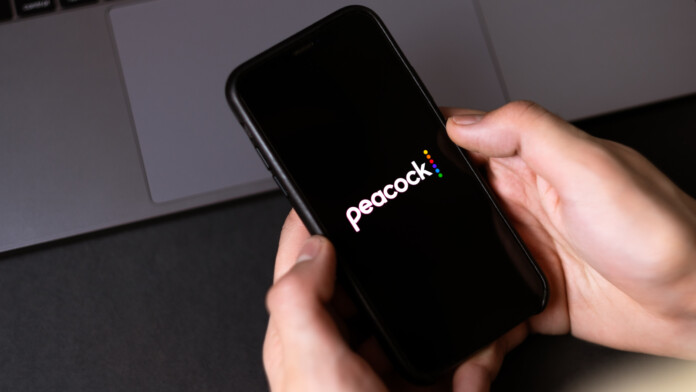 Peacock logo on smartphone screen.