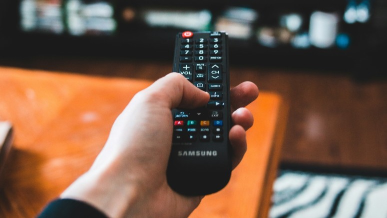 TV Remote Held in Hand