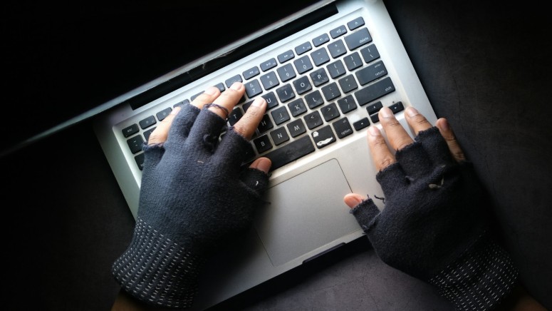 Hacker's Hands on Laptop