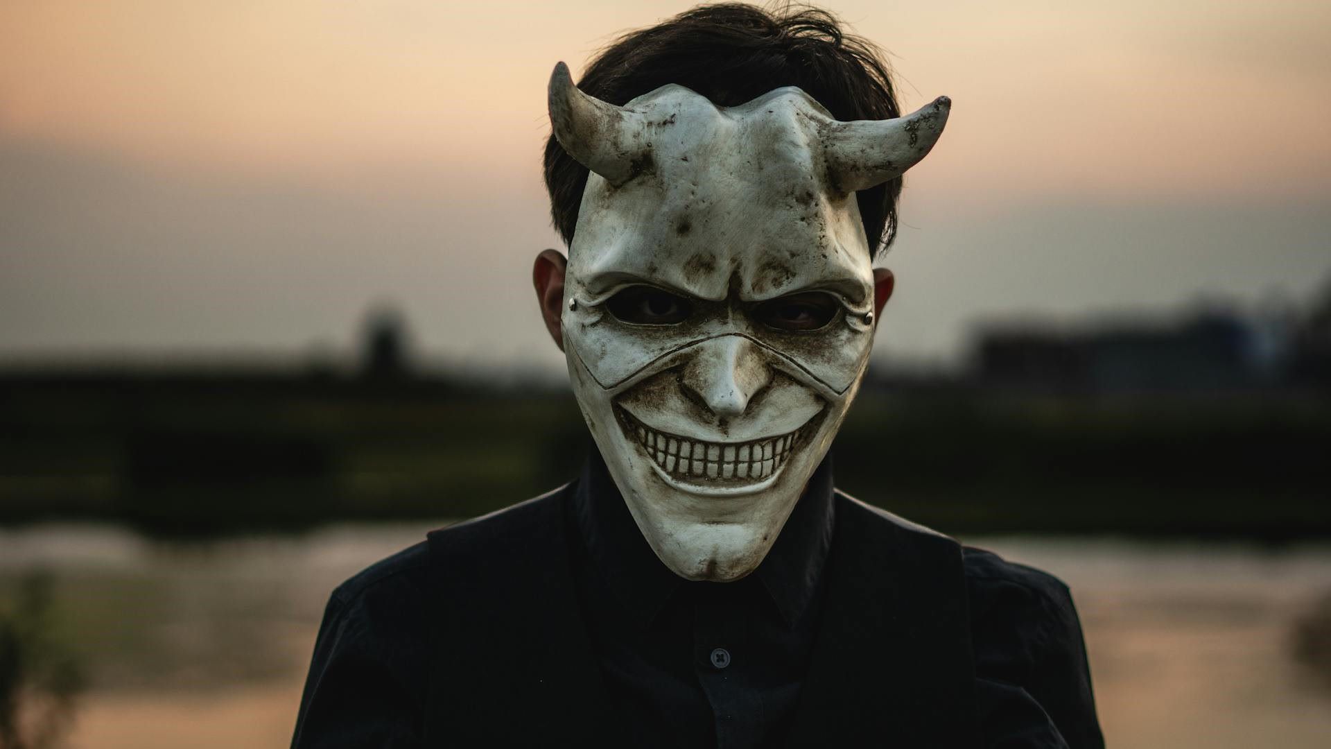 Man Standing Outside in a Scary Halloween Mask