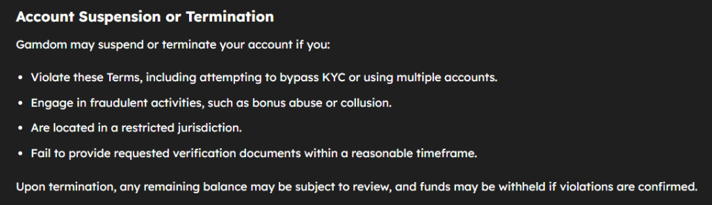 Screenshot of Gamdom’s account suspension policy listing reasons such as violating terms, fraudulent activity, restricted location, and failure to verify identity. Notes that remaining balances may be withheld upon termination.