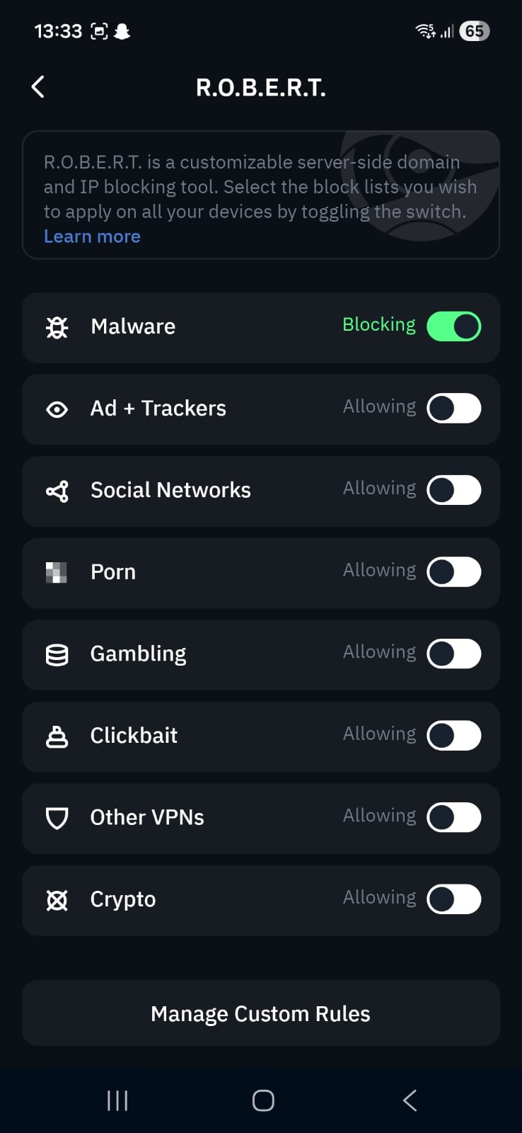 Screenshot of Windscribe’s R.O.B.E.R.T. settings page on mobile, describing it as a customizable server‑side domain and IP blocking tool. Toggles are shown for categories like Malware (enabled), Ads + Trackers, Social Networks, Porn, Gambling, Clickbait, Other VPNs, and Crypto (all disabled). A “Manage Custom Rules” button appears at the bottom.